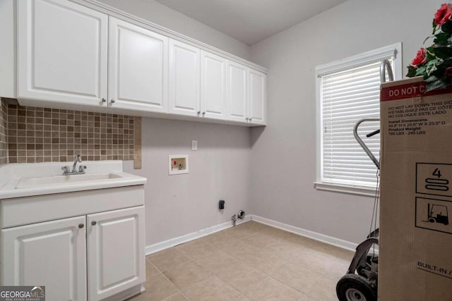 washroom with sink, hookup for a gas dryer, cabinets, washer hookup, and light tile patterned flooring