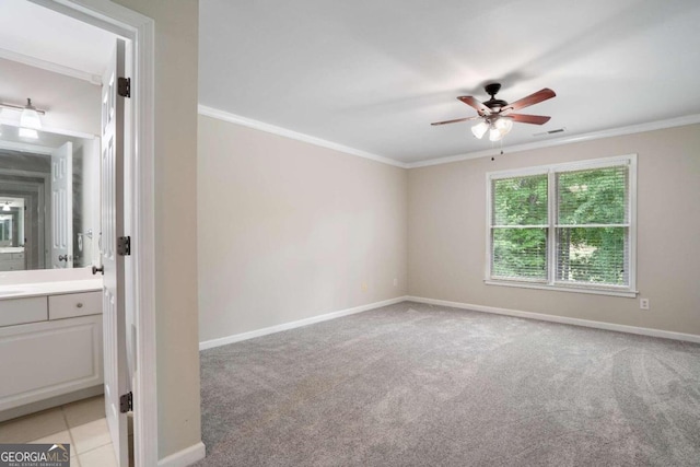 spare room with ornamental molding, light carpet, and ceiling fan