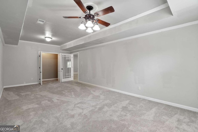 carpeted empty room with ceiling fan and ornamental molding