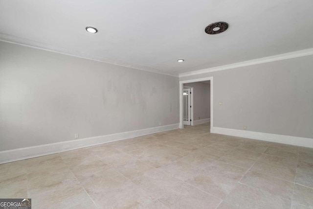 empty room featuring light tile patterned flooring and crown molding