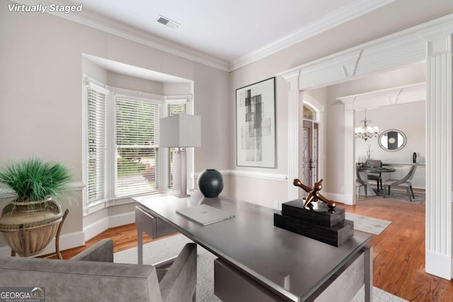 office area featuring ornamental molding, an inviting chandelier, and hardwood / wood-style floors