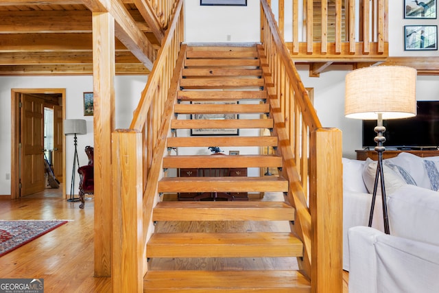 stairway with hardwood / wood-style floors