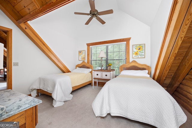 carpeted bedroom featuring ceiling fan, wood ceiling, and vaulted ceiling with beams