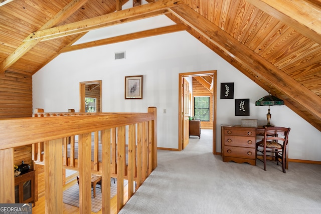 hallway featuring carpet flooring, lofted ceiling with beams, and wooden ceiling