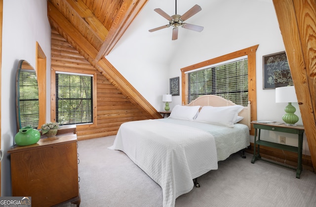 bedroom with high vaulted ceiling, ceiling fan, carpet, and rustic walls