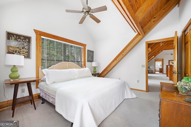 carpeted bedroom with high vaulted ceiling and ceiling fan