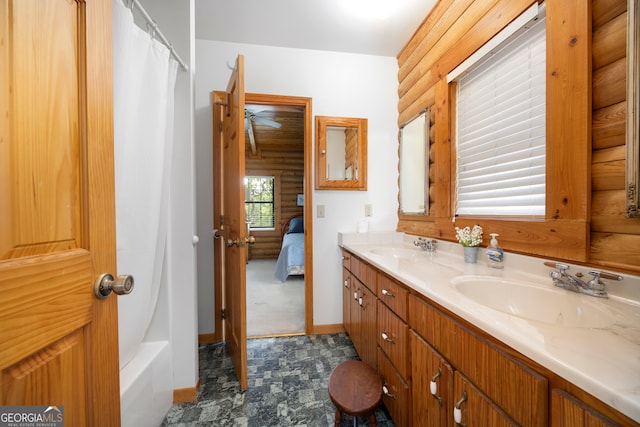 bathroom featuring shower / bathtub combination with curtain and vanity