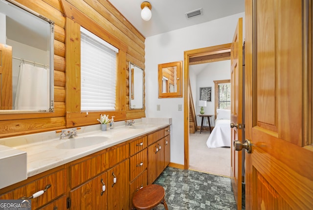 bathroom featuring vanity and wood walls