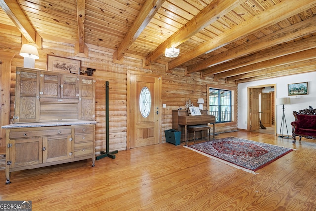 interior space featuring wood ceiling, log walls, light hardwood / wood-style flooring, and beam ceiling