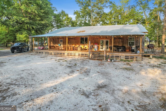 view of front of property with a wooden deck and french doors