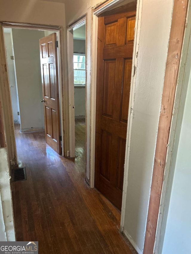 corridor with dark wood-type flooring