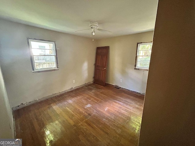 empty room featuring hardwood / wood-style flooring and ceiling fan