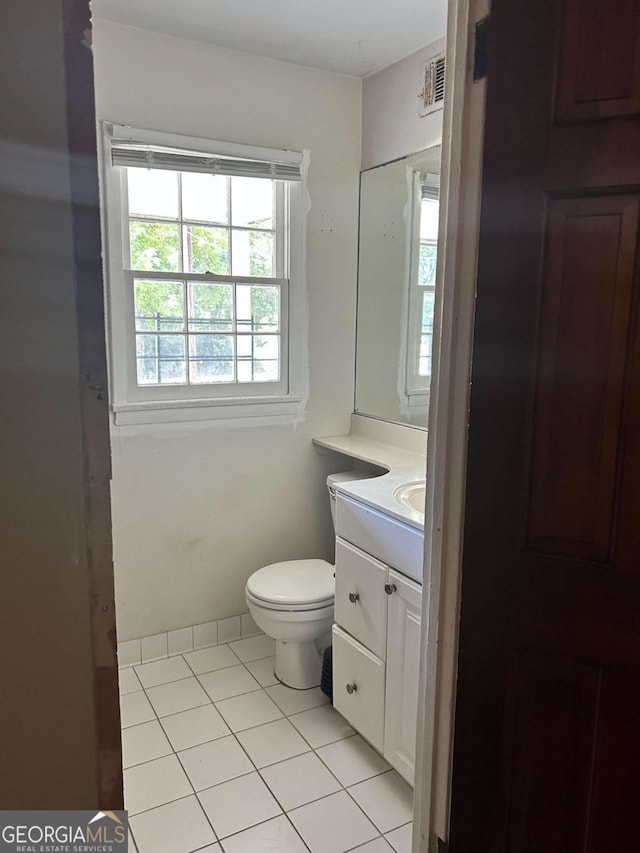 bathroom with vanity, toilet, and tile patterned flooring