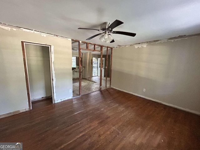 unfurnished room featuring dark hardwood / wood-style floors and ceiling fan