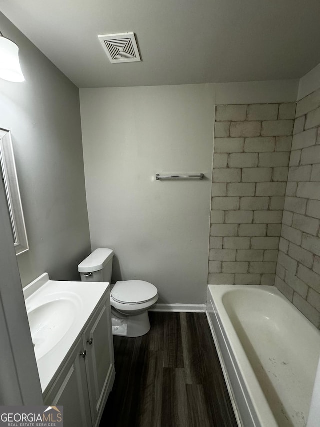 bathroom featuring hardwood / wood-style floors, vanity, and toilet