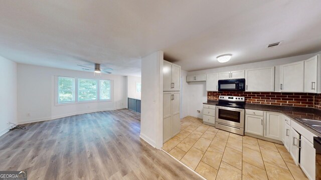 kitchen with light hardwood / wood-style floors, stainless steel electric stove, decorative backsplash, white cabinetry, and ceiling fan