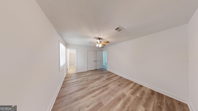 unfurnished room with ceiling fan and light hardwood / wood-style flooring