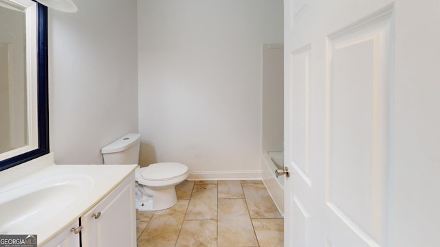 bathroom with vanity, tile patterned flooring, and toilet