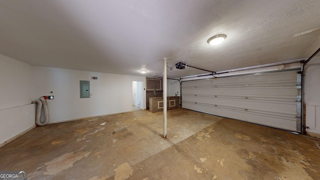 garage with a garage door opener and electric panel