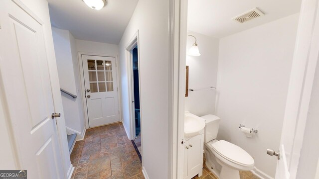 bathroom featuring vanity, toilet, and tile patterned floors