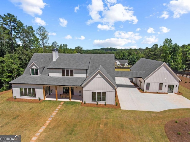 modern farmhouse style home featuring a patio and a front lawn