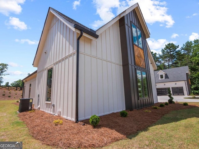 view of property exterior with central air condition unit and a lawn