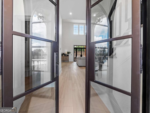 interior space featuring a high ceiling and hardwood / wood-style flooring