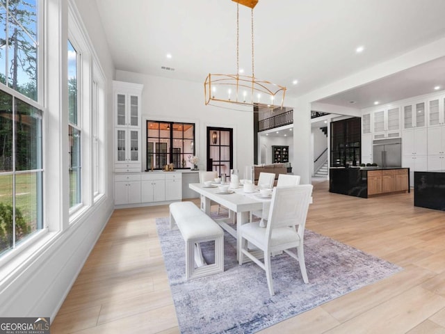 dining area with a chandelier and light wood-type flooring