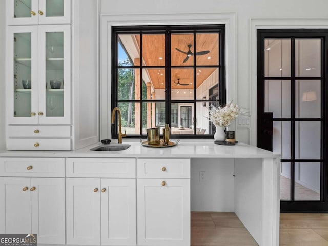 bar featuring white cabinets and sink