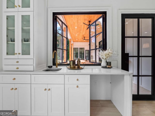 bar featuring sink and white cabinets