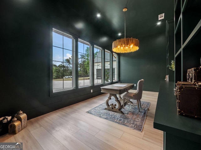 dining space featuring a chandelier, hardwood / wood-style floors, and a towering ceiling