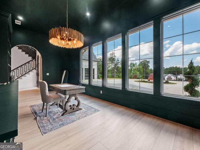 dining room with wood-type flooring and a chandelier