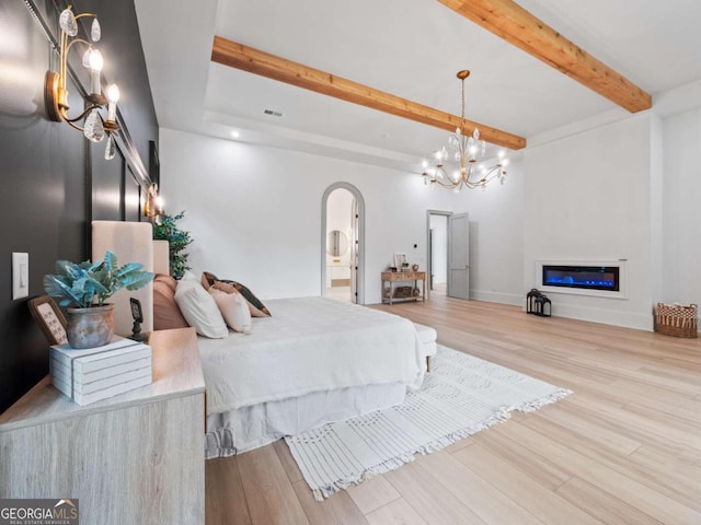 bedroom featuring wood-type flooring and a notable chandelier