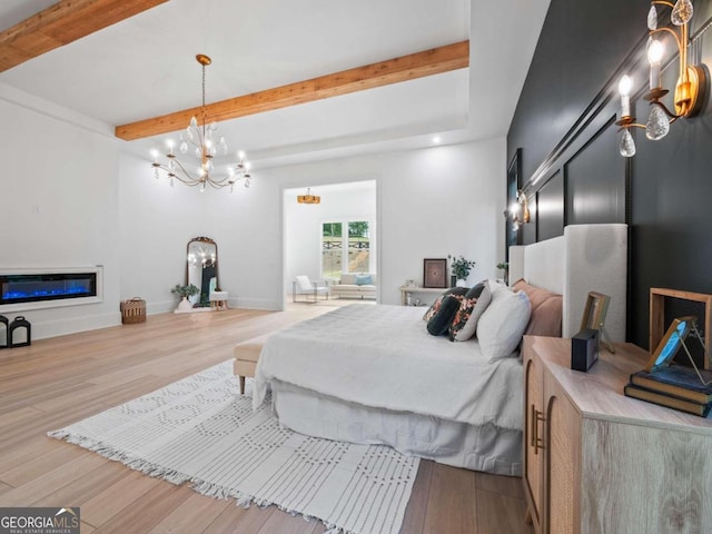 bedroom featuring beamed ceiling, an inviting chandelier, and light hardwood / wood-style flooring