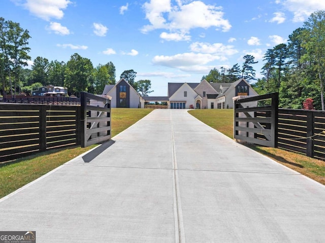 view of gate with a lawn