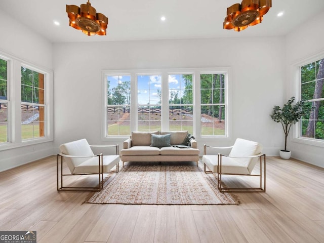 sunroom / solarium featuring a notable chandelier and a wealth of natural light