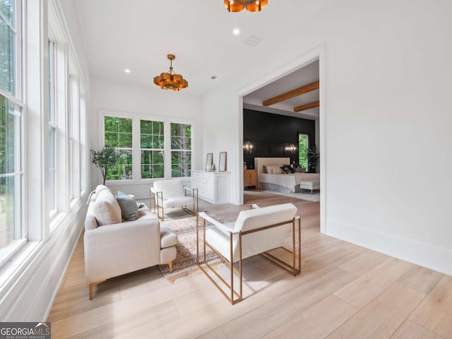 living room featuring light hardwood / wood-style floors and a notable chandelier