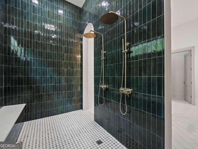 bathroom with tile patterned floors and a tile shower