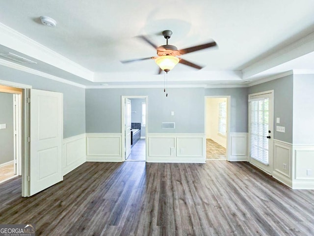 unfurnished living room featuring ceiling fan, a tray ceiling, and crown molding