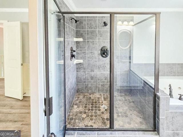 bathroom featuring ornamental molding, wood-type flooring, and an enclosed shower