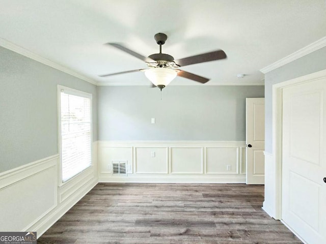 spare room featuring ceiling fan, ornamental molding, and hardwood / wood-style flooring