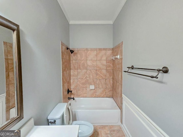 bathroom featuring toilet, tile patterned floors, crown molding, and tiled shower / bath