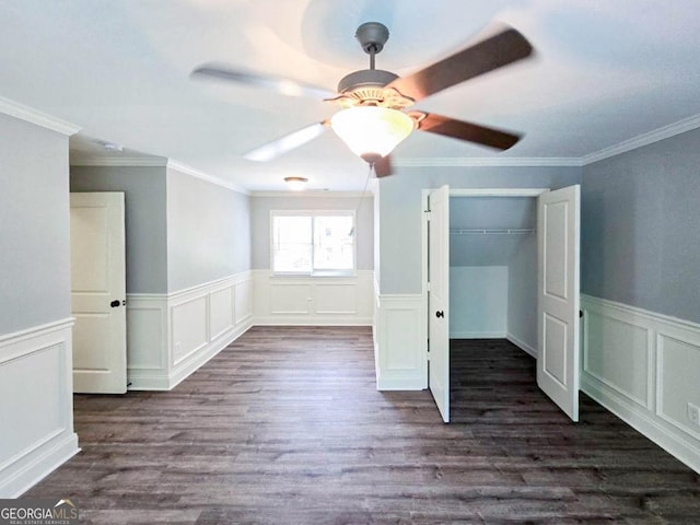 unfurnished bedroom featuring ceiling fan, dark wood-type flooring, a closet, and crown molding