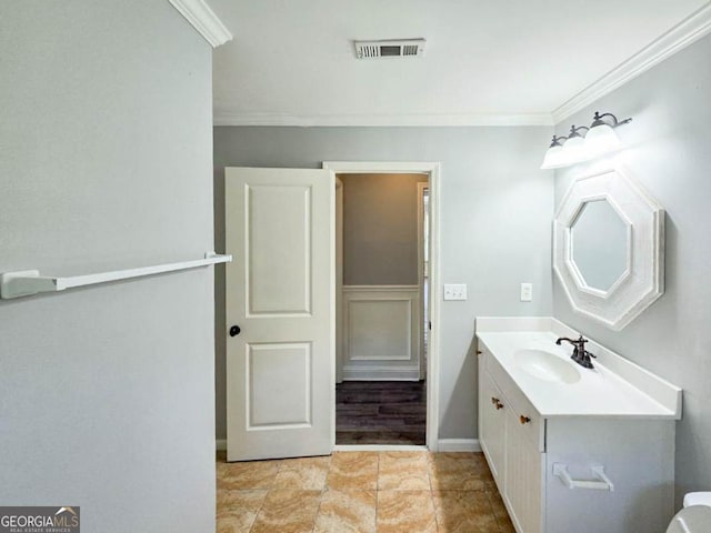 bathroom with vanity and ornamental molding