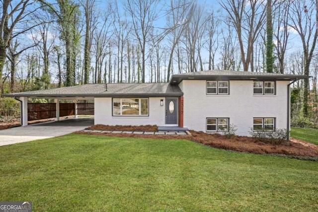 split level home featuring a carport and a front yard