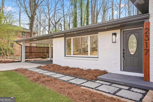 view of exterior entry featuring a carport