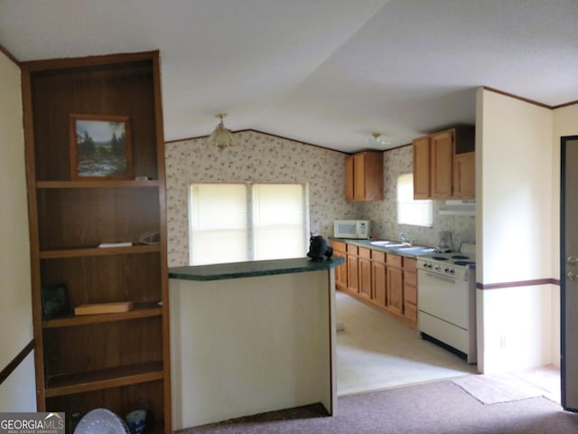 kitchen with white appliances, light colored carpet, and lofted ceiling