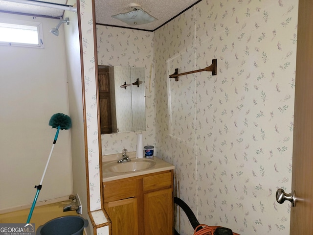 bathroom featuring a textured ceiling and vanity