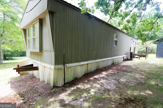 view of side of property with central air condition unit