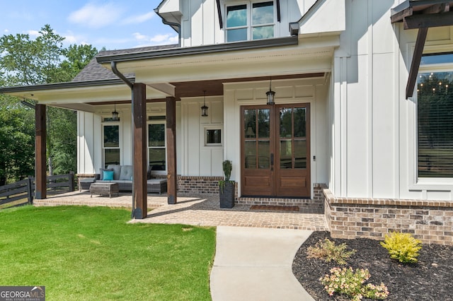 entrance to property with a yard and covered porch